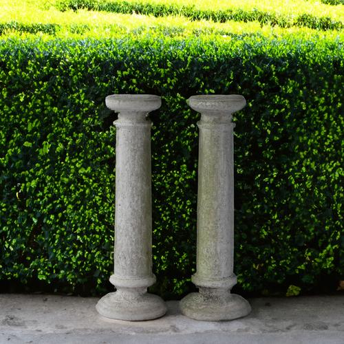 A PAIR OF WHITE PAINTED RECONSTITUTED STONE TURNED COLUMNS (2)