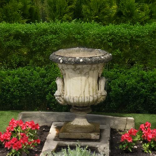A RECONSTITUTED STONE TWIN HANDLE JARDINIERE