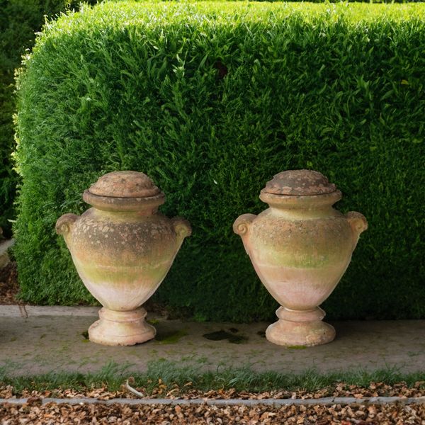 A PAIR OF TERRACOTTA BALUSTER SHAPED TWIN HANDLE LIDDED GARDEN URNS (2)