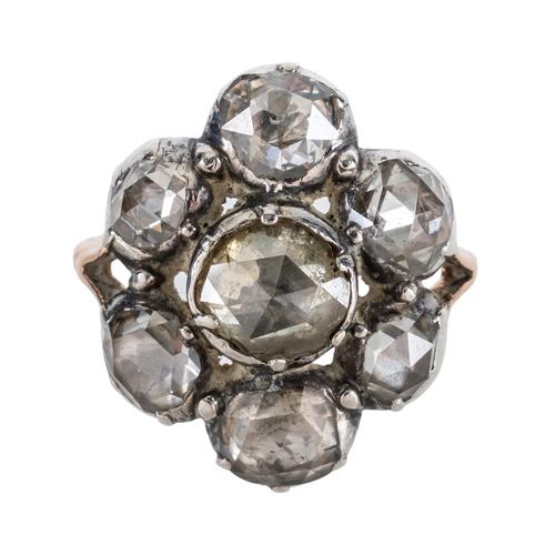 A GOLD AND SILVER SET ROSE DIAMOND SEVEN STONE CLUSTER RING