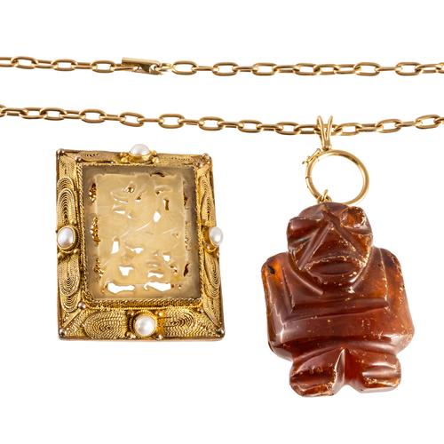 A CARVED AMBER PENDANT AND A BROOCH