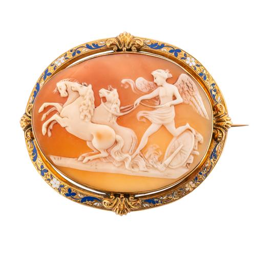 A GOLD AND ENAMEL MOUNTED OVAL SHELL CAMEO BROOCH