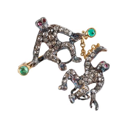 A DIAMOND SET SWINGING MONKEY BROOCH