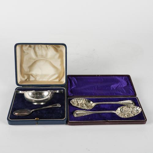 A SILVER TWIN HANDLED CHRISTENING BOWL, AN ASSOCIATED SILVER SPOON AND A PAIR OF PLATED FRUIT SERVING SPOONS (4)