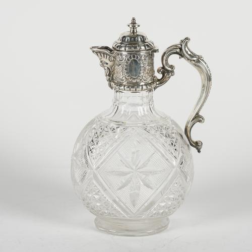 A LATE VICTORIAN SILVER MOUNTED HINGE LIDDED CUT GLASS CLARET JUG