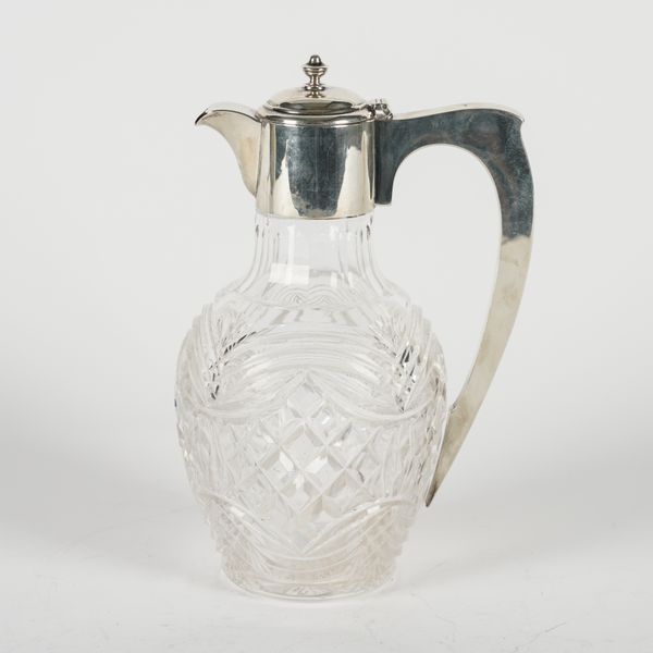 A SILVER MOUNTED CUT GLASS CLARET JUG