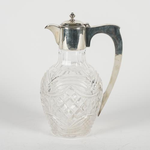 A SILVER MOUNTED CUT GLASS CLARET JUG