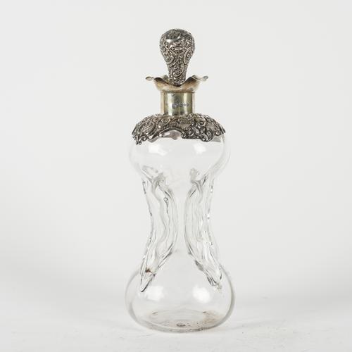 A LATE VICTORIAN SILVER MOUNTED DIMPLED GLASS DECANTER AND STOPPER