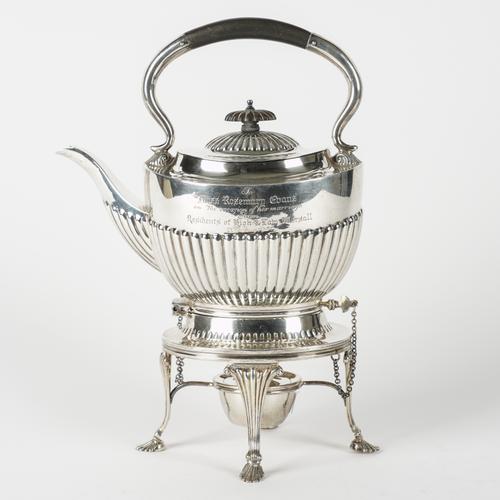 A SILVER SPIRIT KETTLE WITH A SILVER STAND AND A SILVER BURNER