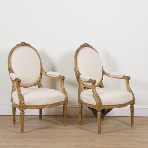 A PAIR OF LOUIS XVI GILT FRAMED OPEN ARMCHAIRS (2)