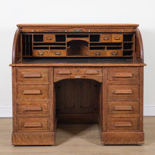 A LATE VICTORIAN OAK ROLL TOP DESK