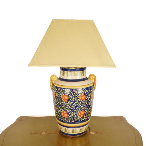 A LARGE PAINTED TERRACOTTA TABLE LAMP
