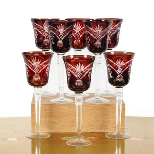 A SET OF EIGHT CRANBERRY COLOURED CUT GLASS DRINKING GLASSES (8)