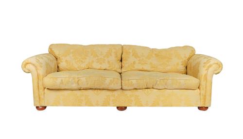 A LARGE YELLOW UPHOLSTERED THREE SEAT SOFA