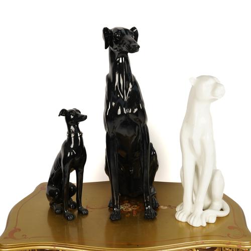 A BLACK RESIN FIGURE OF A SEATED GREYHOUND (3)