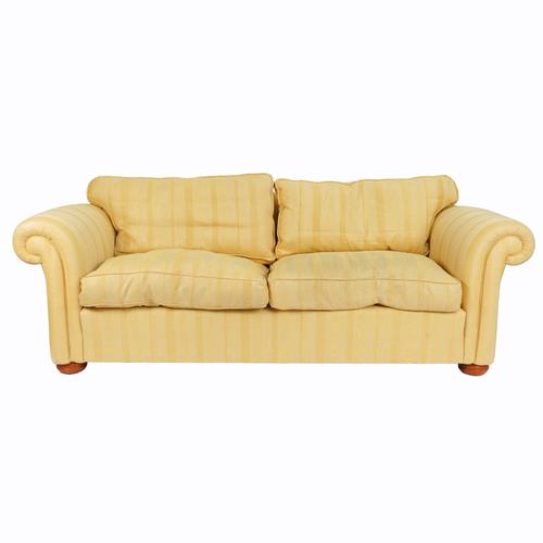 A YELLOW STRIPED UPHOLSTERED THREE SEAT SOFA