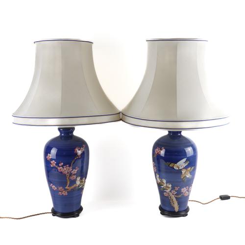 A PAIR OF CHINESE BLUE GROUND AND PINK CHERRY BLOSSOM DECORATED BALUSTER TABLE LAMPS (2)