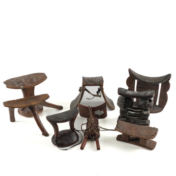 TRIBAL INTEREST: A GROUP OF WOOD HEADRESTS INCLUDING A LUBA AND POKOT EXAMPLES (8)