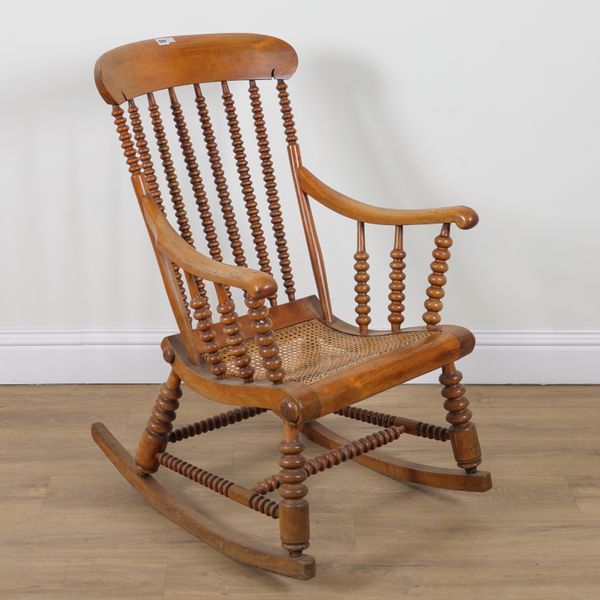 A 19TH CENTURY STAINED BEECH BOBBIN TURNED ROCKING ARMCHAIR