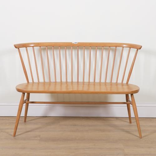 ERCOL; A MID 20TH CENTURY SPINDLE BACK ELM BENCH