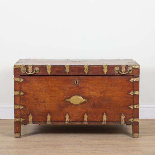 A 19TH CENTURY BRASS BOUND TEAK LIFT TOP TRUNK