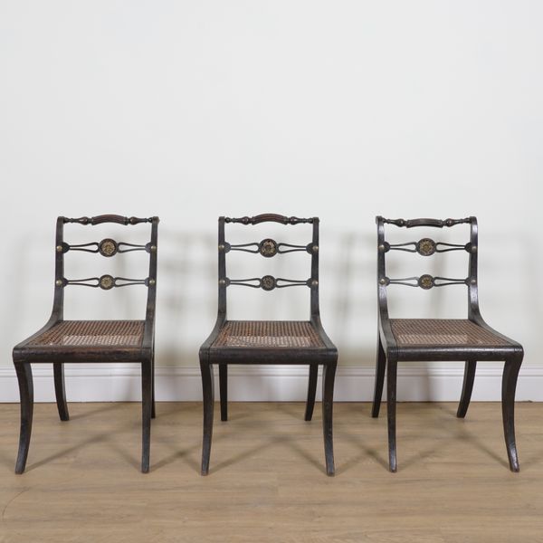 A SET OF THREE REGENCY EBONISED GILT METAL MOUNTED DINING CHAIRS (3)