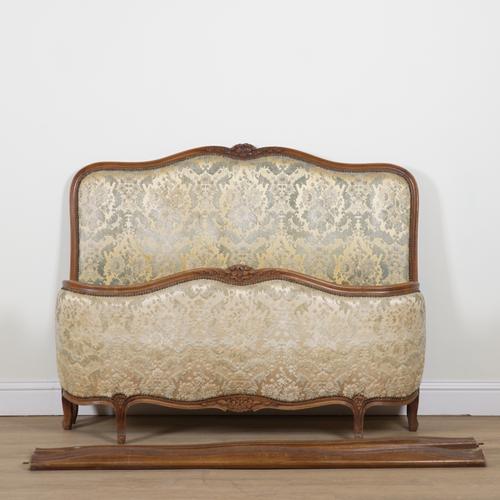A FRENCH STAINED BEECH UPHOLSTERED DOUBLE BED