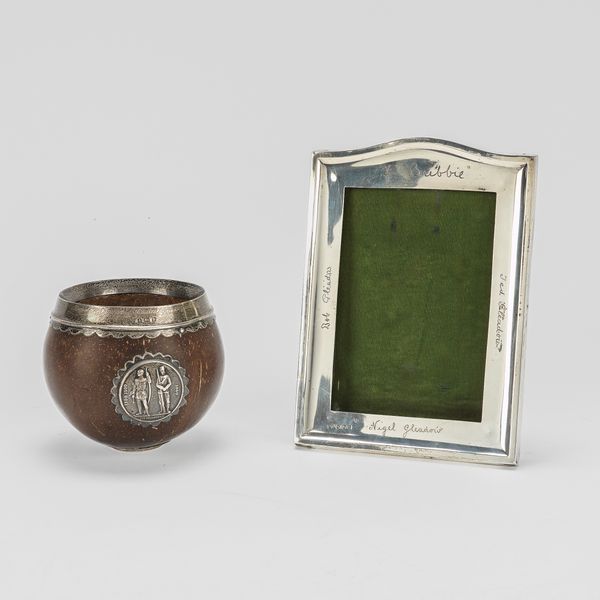 A SILVER MOUNTED PHOTOGRPAH FRAME AND A SILVER MOUNTED COCONUT BOWL (2)