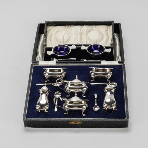 A PAIR OF SILVER SALTS AND A PLATED CONDIMENT SET (2)