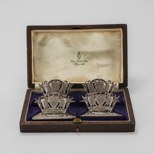 A SET OF FOUR SILVER MENU STANDS DESIGNED AS NAVAL CROWNS