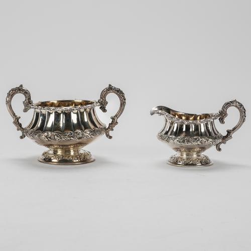 A SILVER TWIN HANDLED SUGAR BOWL AND A MATCHING MILK JUG (2)