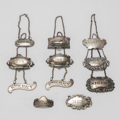 FOUR SILVER DECANTER LABELS AND SEVEN PLATED DECANTER LABELS (11)