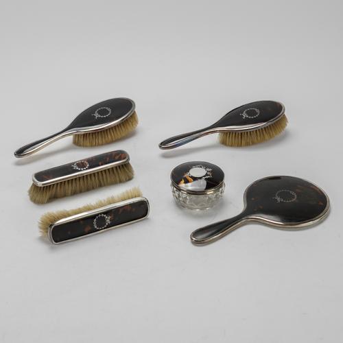 A GROUP OF SILVER AND TORTOISESHELL MOUNTED DRESSING TABLE WARES (6)