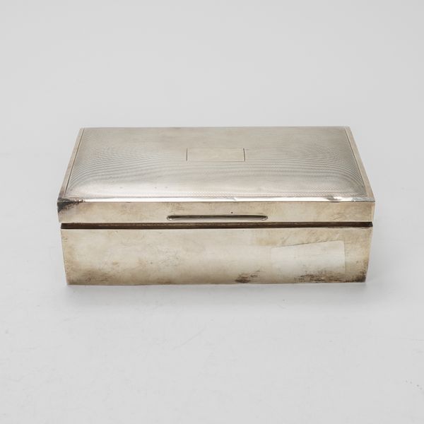A SILVER RECTANGULAR TABLE CIGARETTE BOX