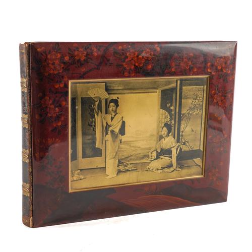 JAPAN - An album of 50 colour-tinted mounted photographs of Japan in a lacquer album, the photographs 195 x 250mm., the oblong 4to album 325 x 420mm., with a sepia photograph inset into the upper cover (some minor chipping), [c.1880].