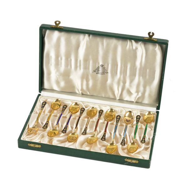 A CASED SET OF TWELVE SWEDISH SILVER GILT AND ENAMELLED COFFEE SPOONS