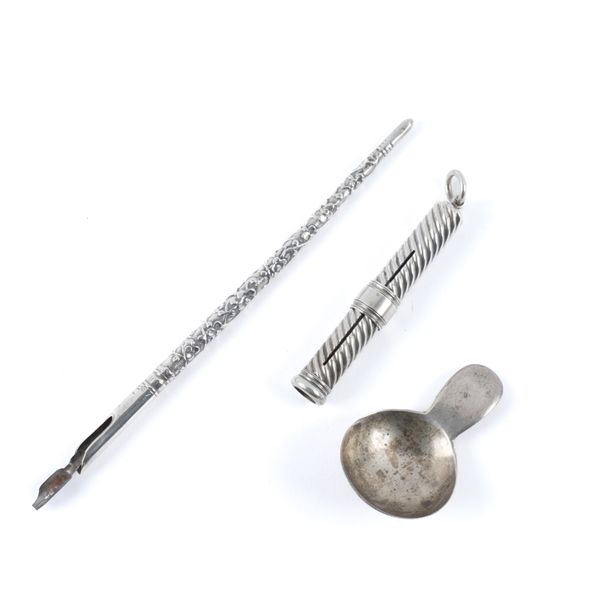 A GEORGE III SILVER CADDY SPOON AND TWO WRITING IMPLEMENTS (3)