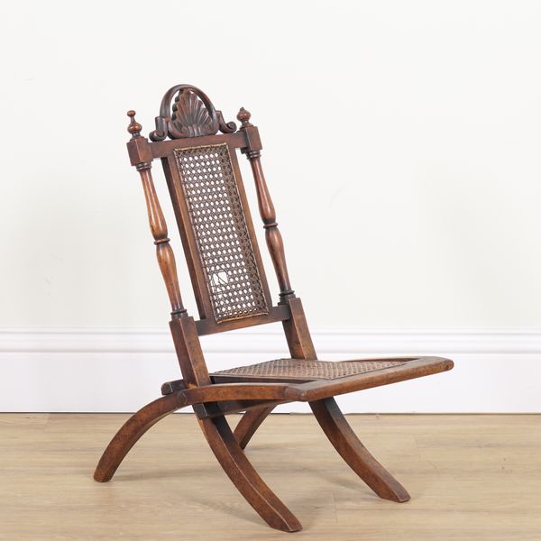 A 19TH CENTURY FRUITWOOD FOLDING CHILD'S CANE CHAIR