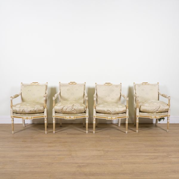 A SET OF FOUR LOUIS XVI STYLE CREAM PAINTED PARCEL GILT OPEN ARMCHAIRS (4)