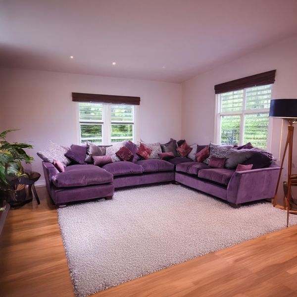 COLLINS & HAYES; A LARGE PURPLE MODULAR CORNER SOFA