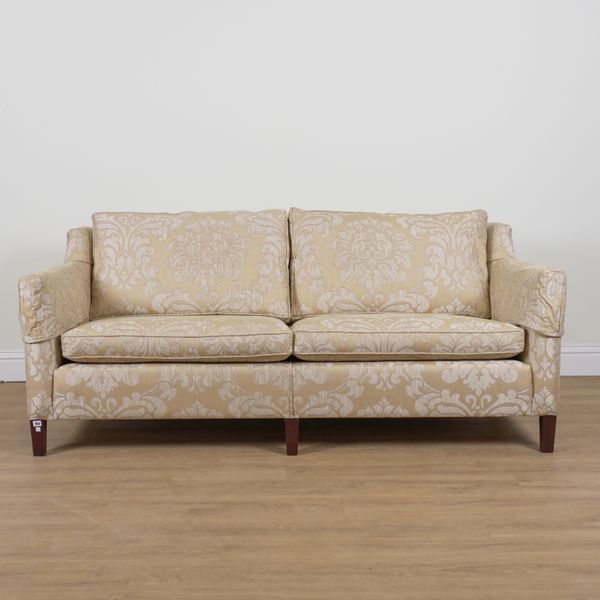 DURESTA; A GOLD FOLIATE UPHOLSTERED TWO SEAT WINGBACK SOFA