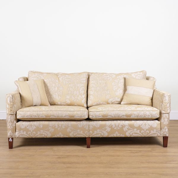 DURESTA; A GOLD FOLIATE UPHOLSTERED TWO SEAT WINGBACK SOFA