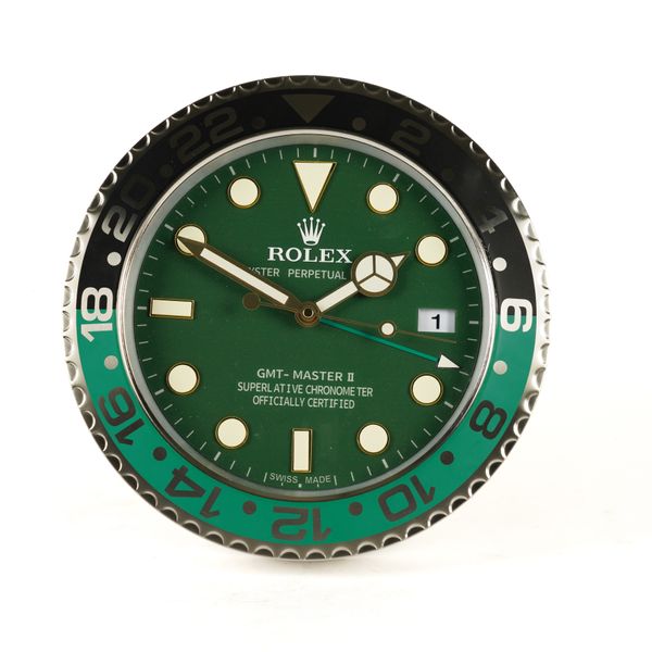 A METAL WALL CLOCK IN THE STYLE OF A ROLEX GMT MASTER II