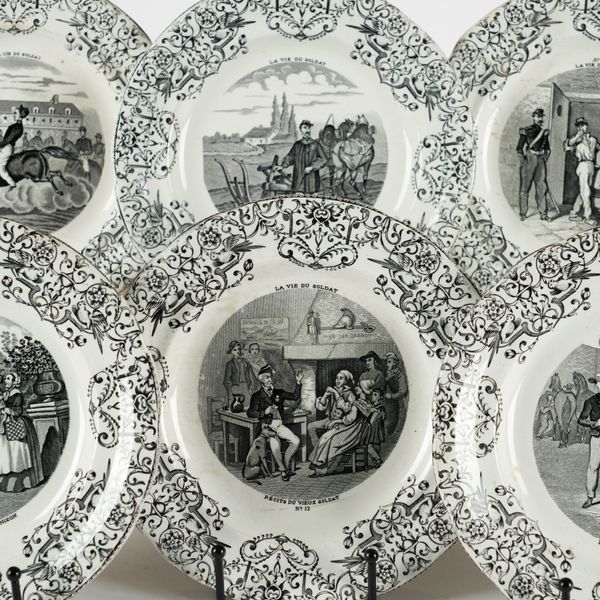 EIGHT GIEN EARTHENWARE `TALKING' PLATES (8)