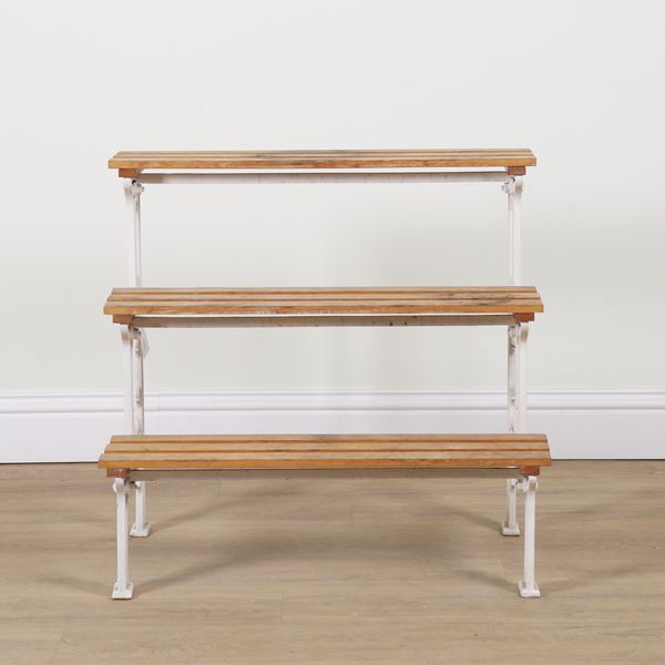 A BARTLETT & SON; A WHITE PAINTED CAST IRON THREE-TIER WATERFALL PLANT STAND