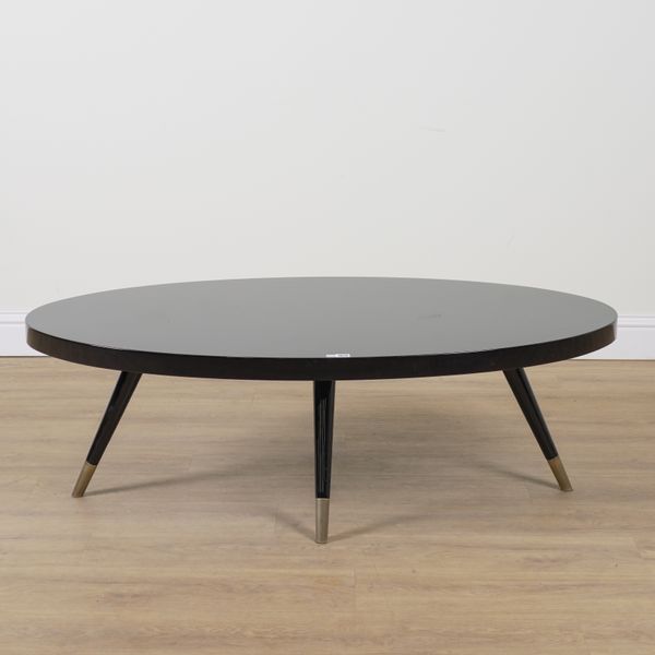 DOM EDIZIONI; AN EBONISED OVAL OCCASIONAL TABLE ON METAL SUPPORTS