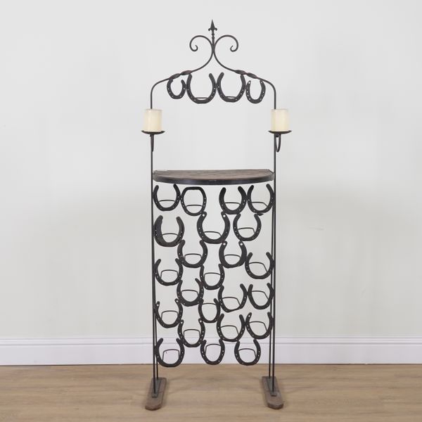 A WROUGHT IRON TWENTY THREE DIVISION HORSESHOE WINE RACK