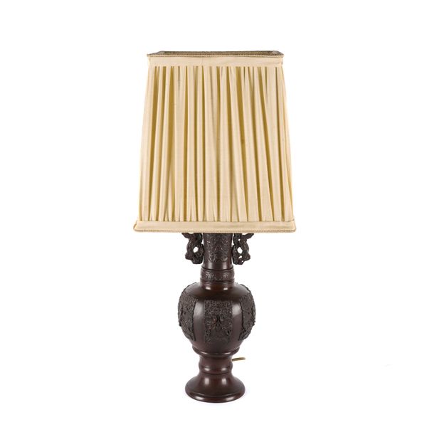 A SOUTH EAST ASIAN BRONZE PATINATED METAL BALUSTER VASE-SHAPED TABLE LAMP