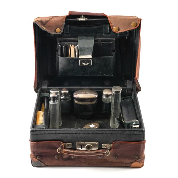 A LEATHER TRAVELLING TOILET CASE