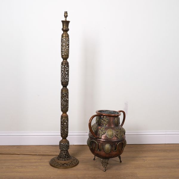 A NORTH AFRICAN PIERCED BRASS FLOOR STANDING LIGHT AND A MOROCCAN BRASS MOUNTED COPPER TWIN HANDLED URN  (2)